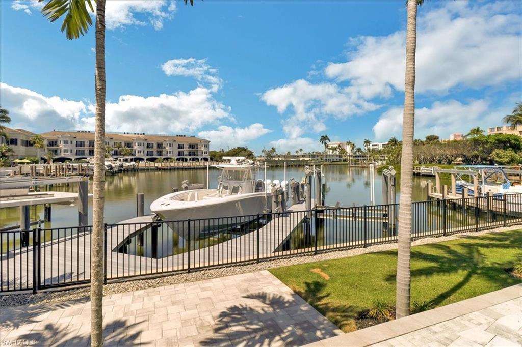 1425 Crayton Road Naples, FL 34102 - Photo 29 of 31 Dock area with a water view and a lawn