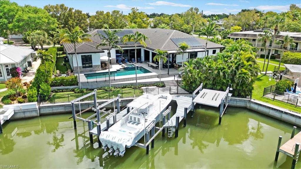 1425 Crayton Road Naples, FL 34102 - Photo 30 of 31 Dock area featuring a patio area and a water view