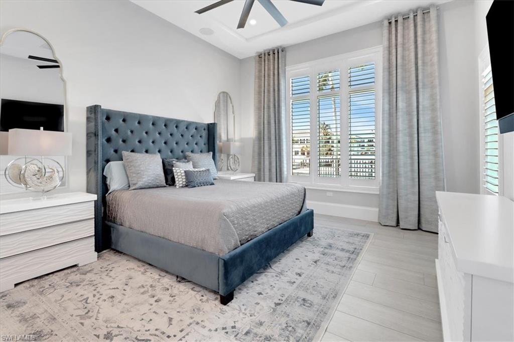 1425 Crayton Road Naples, FL 34102 - Photo 10 of 31 Bedroom with light hardwood / wood-style floors and ceiling fan