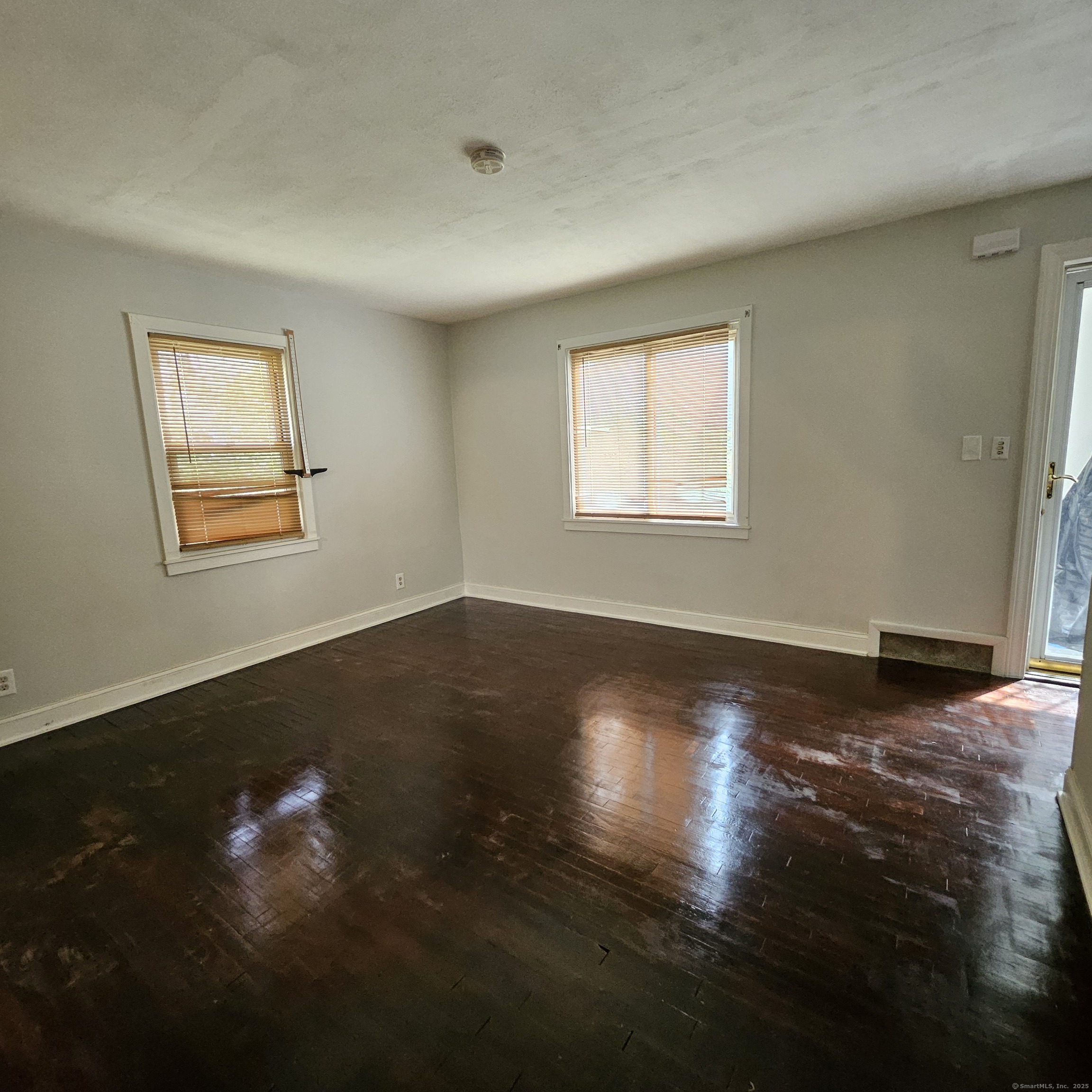 430 Pearl Harbor Street Bridgeport, CT 06610 - Photo 2 of 12 a view of room window and wooden floor