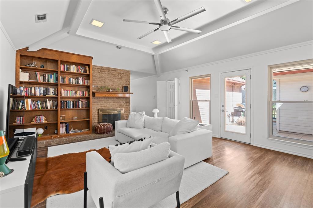 3506 Ruidoso Drive Arlington, TX 76017 - Photo 8 of 37 Living area featuring a vaulted ceiling and wood-finish flooring