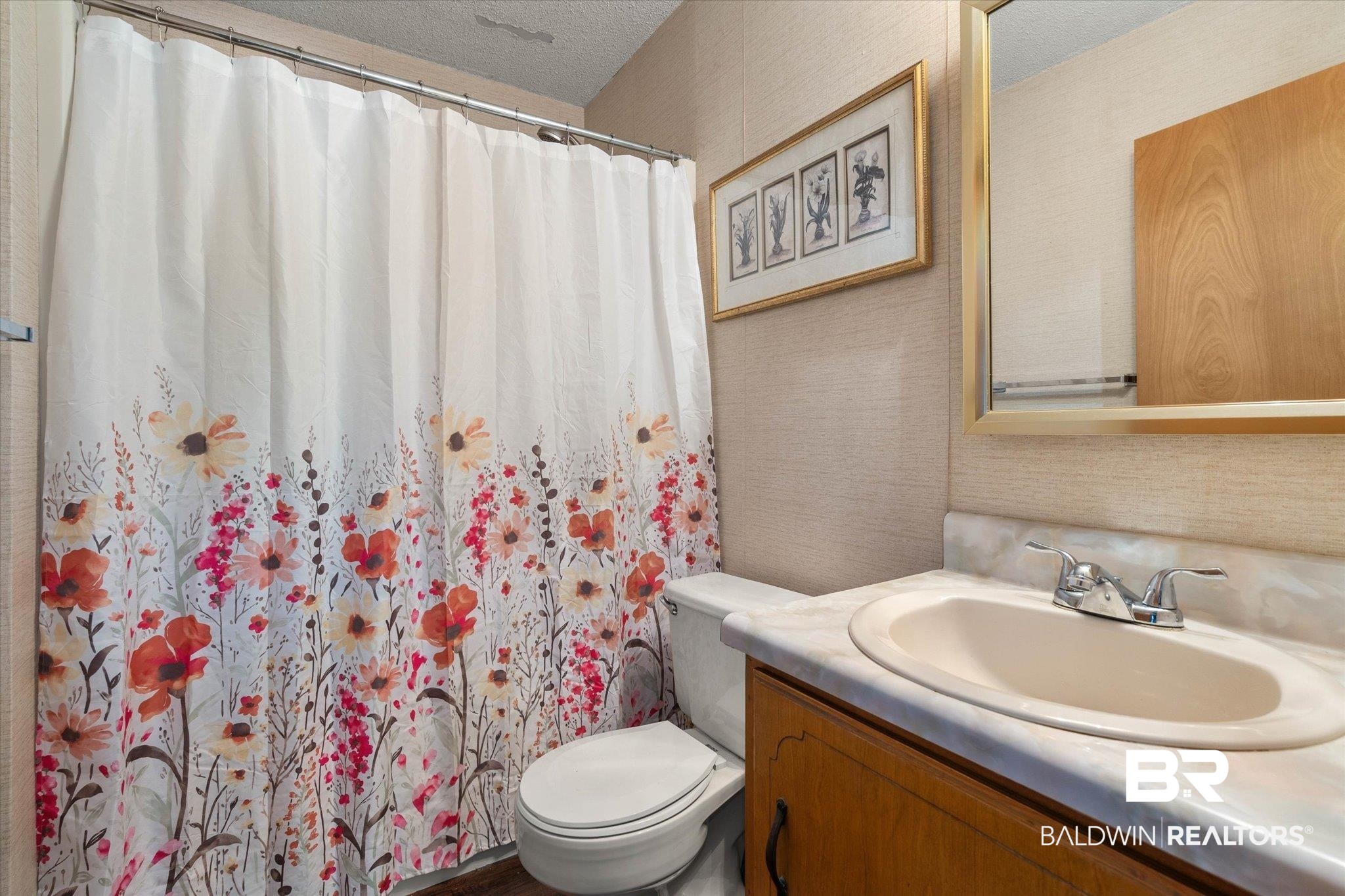 5503 Darring Street Satsuma, AL 36572 - Photo 19 of 31 Bathroom with vanity, a textured ceiling, wallpapered walls, and curtained shower
