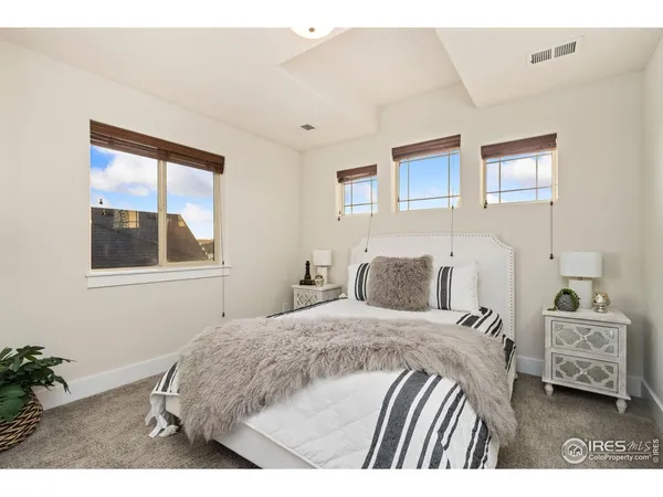 a bedroom with furniture and a chandelier