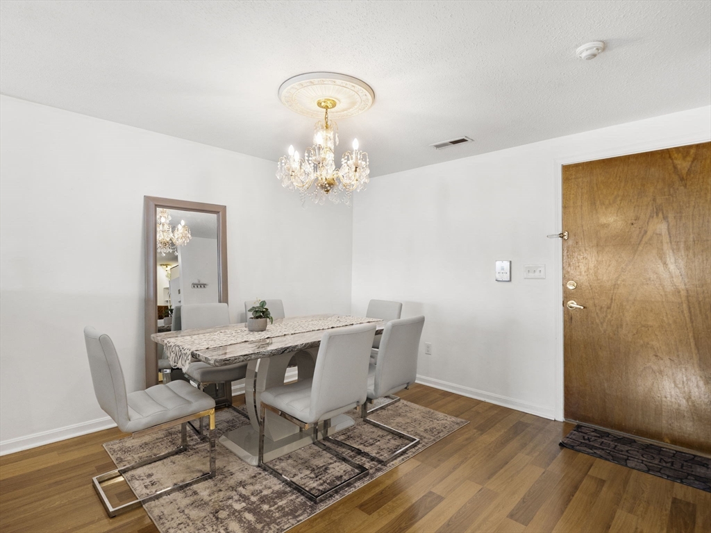 34 Newhall Street, Unit 412 Lowell, MA 01852 - Photo 12 of 30 a view of a dining room with furniture and wooden floor