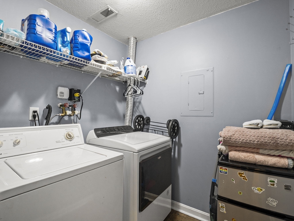 34 Newhall Street, Unit 412 Lowell, MA 01852 - Photo 24 of 30 a utility room with dryer and washer