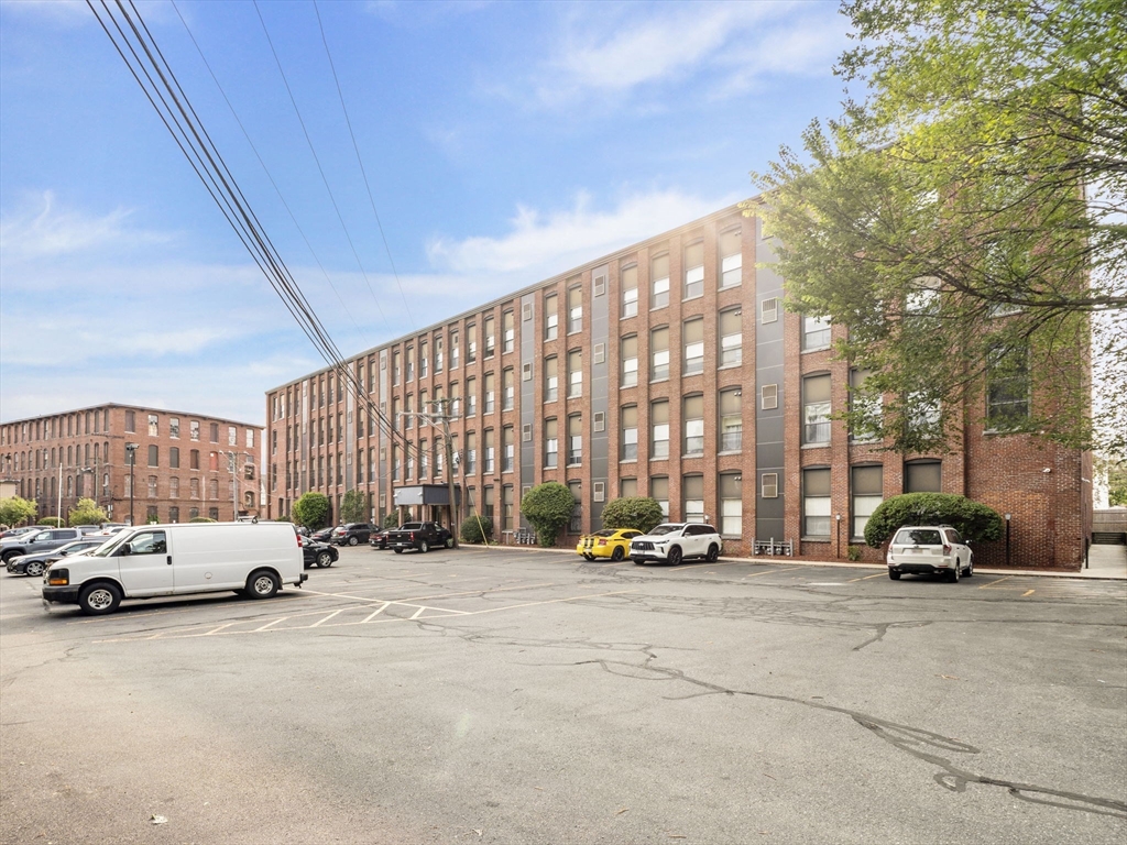 34 Newhall Street, Unit 412 Lowell, MA 01852 - Photo 26 of 30 a view of cars parked in front of a building