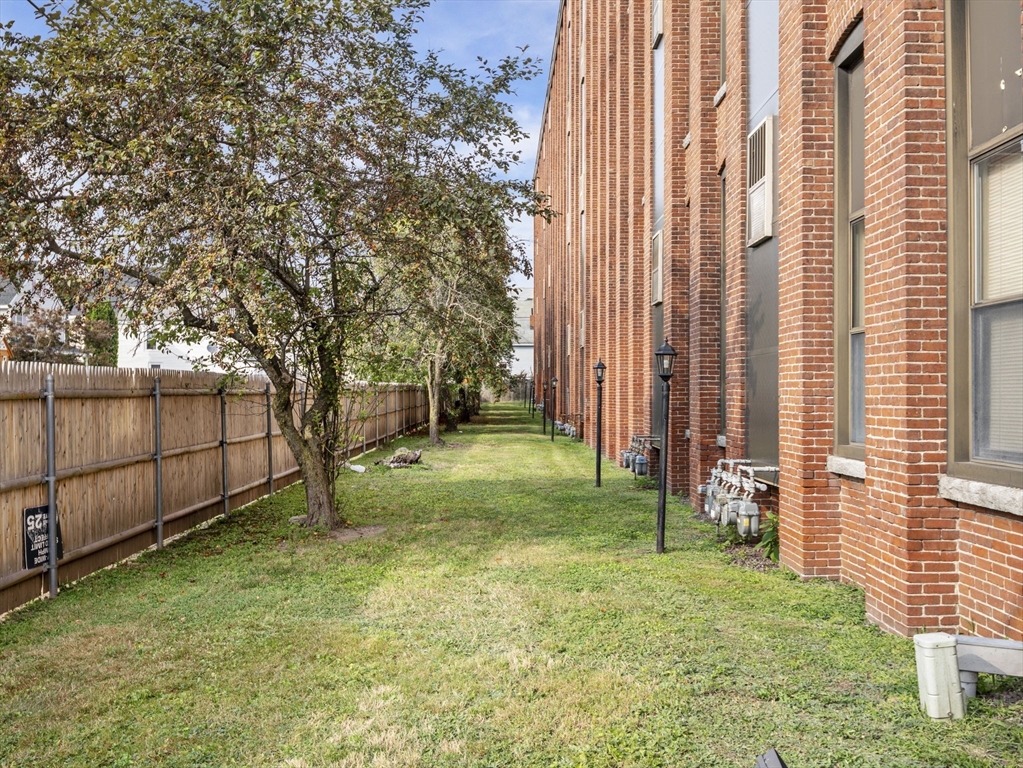 34 Newhall Street, Unit 412 Lowell, MA 01852 - Photo 29 of 30 a view of backyard with tub and trees