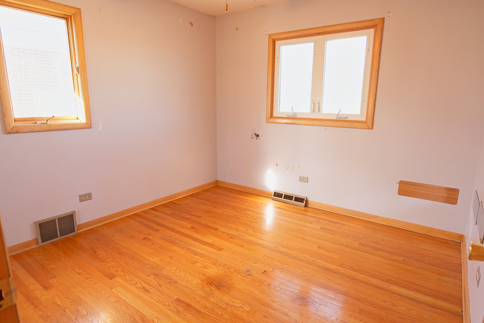 6432 Cedar Road Oak Forest, IL 60452 - Photo 8 of 14 a view of an empty room with wooden floor and a window
