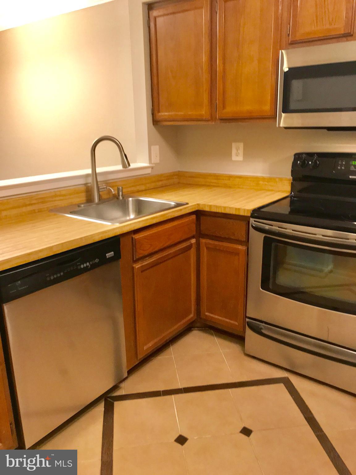 7702 Lexton Place, Unit 65 Springfield, VA 22152 - Photo 8 of 24 a kitchen with a sink and a stove top oven