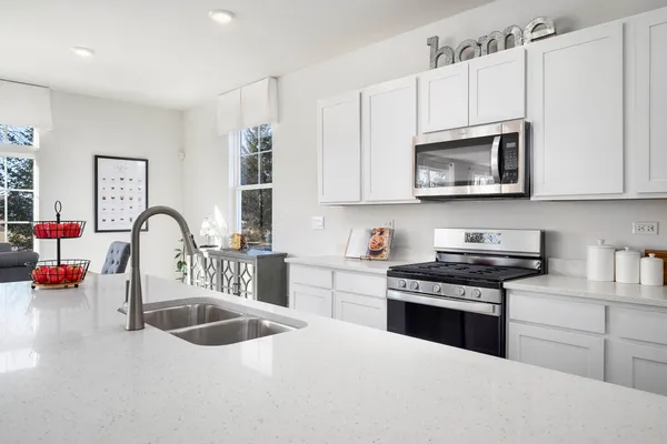a kitchen with sink refrigerator and window