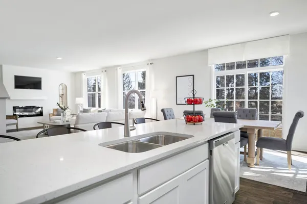 a kitchen with stainless steel appliances granite countertop a sink stove and cabinets