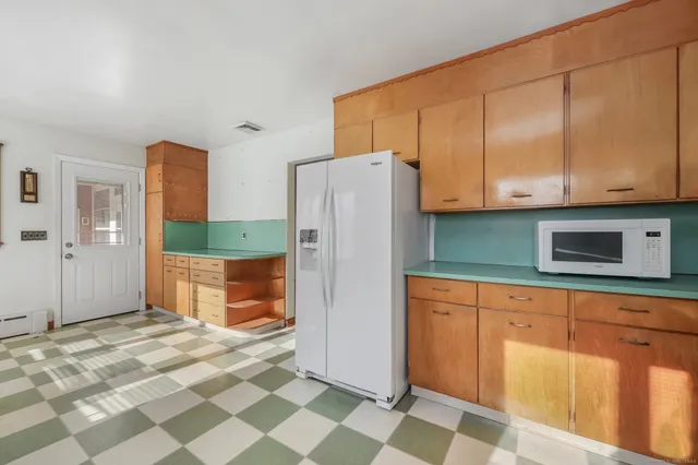 a kitchen with stainless steel appliances granite countertop a refrigerator and a sink