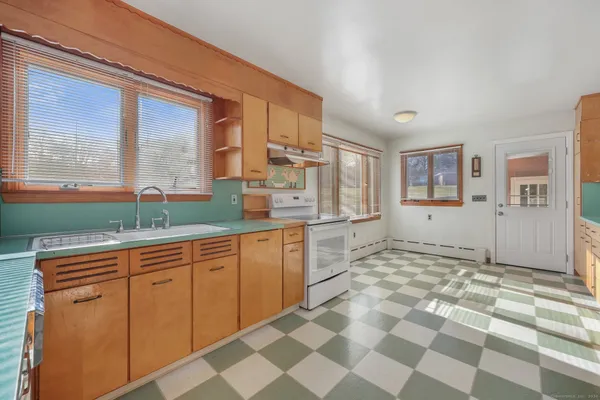 a large kitchen with stainless steel appliances granite countertop a sink and a stove