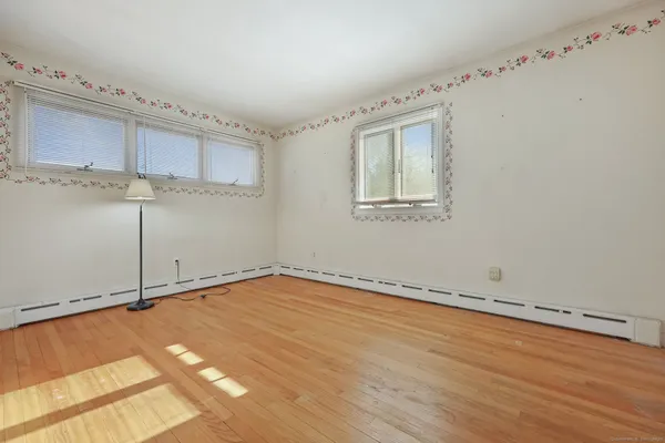 a view of a room with wooden floor and cabinet