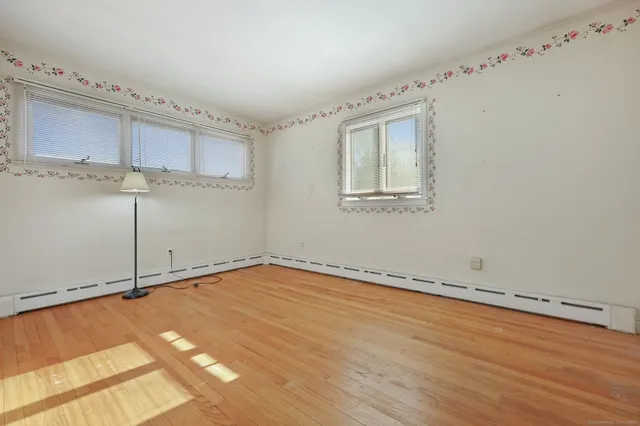a view of a room with wooden floor and cabinet