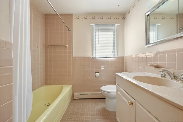 a bathroom with a sink a toilet and bathtub