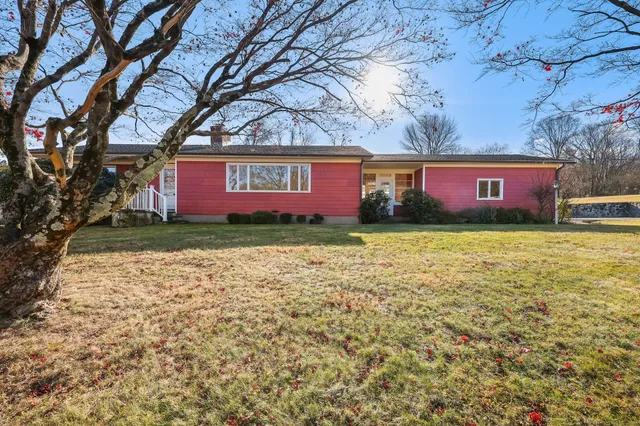 a front view of house with yard and trees