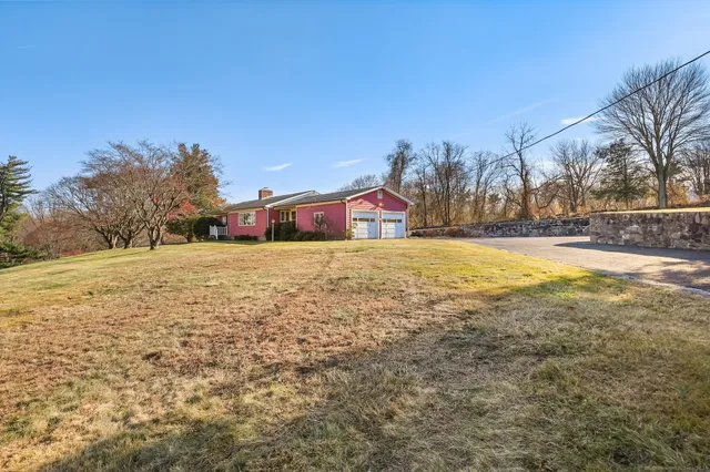 a view of a field with trees in the background
