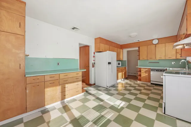 a kitchen with sink cabinets and refrigerator