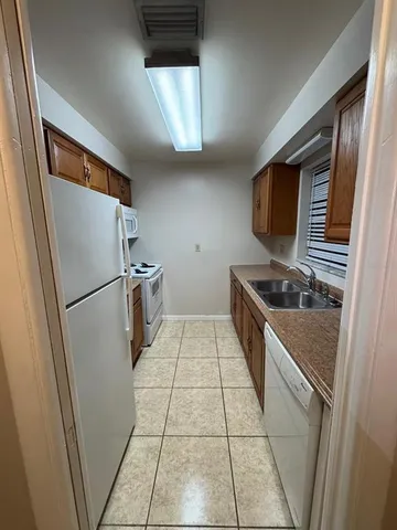 a kitchen with stainless steel appliances a refrigerator and a stove top oven
