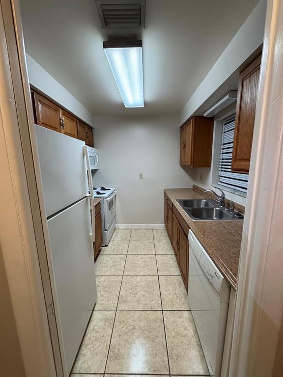 2050 Oleander Boulevard, Unit 4203 Fort Pierce, FL 34950 - Photo 4 of 15 a kitchen with stainless steel appliances a refrigerator and a stove top oven