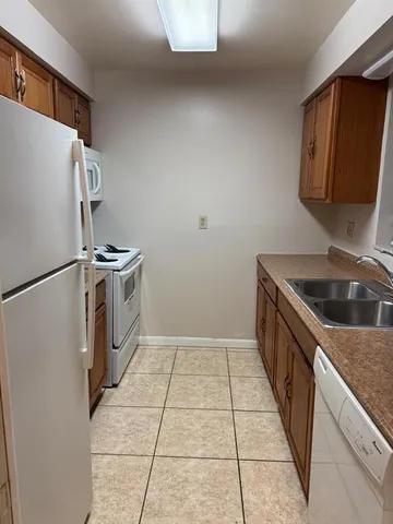 a kitchen with a stove top oven and cabinets