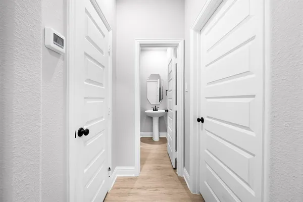 a view of a hallway with wooden floor