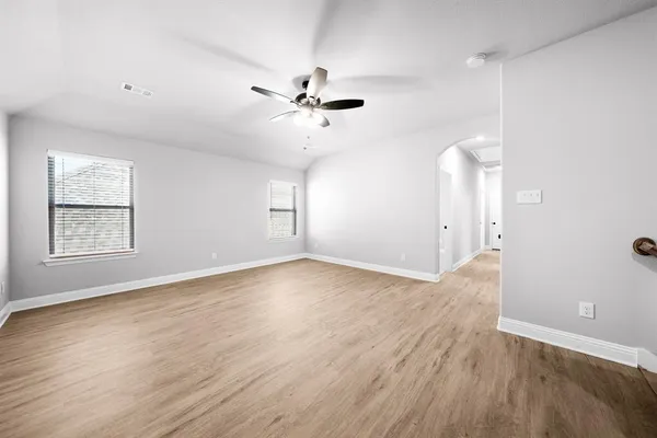 a view of a hallway with wooden floor and entryway