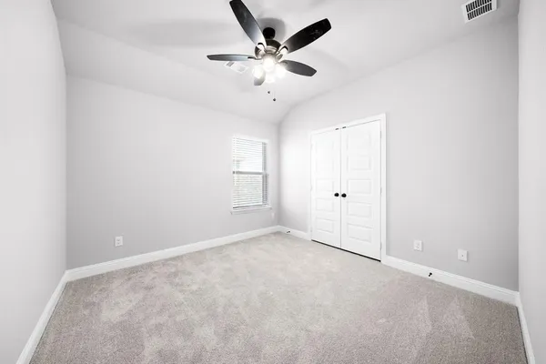 a view of a hallway with wooden floor and closet