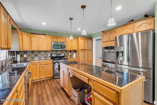 a kitchen with stainless steel appliances a refrigerator sink and microwave