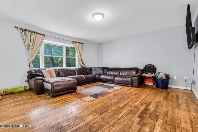 a living room with furniture window and flat screen tv