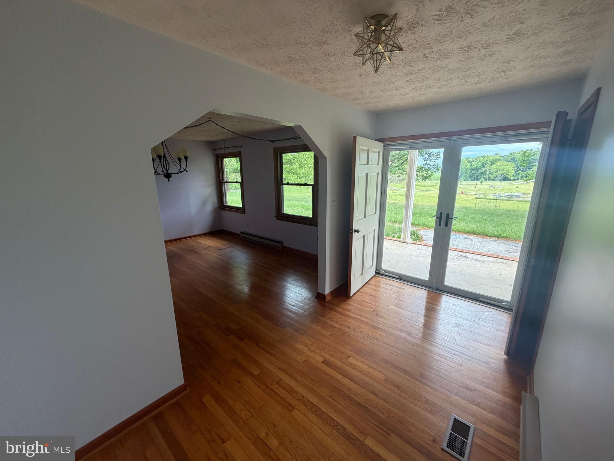 116 Rehoboth Lane Summit Point, WV 25446 - Photo 3 of 14 wooden floor in an empty room with a window