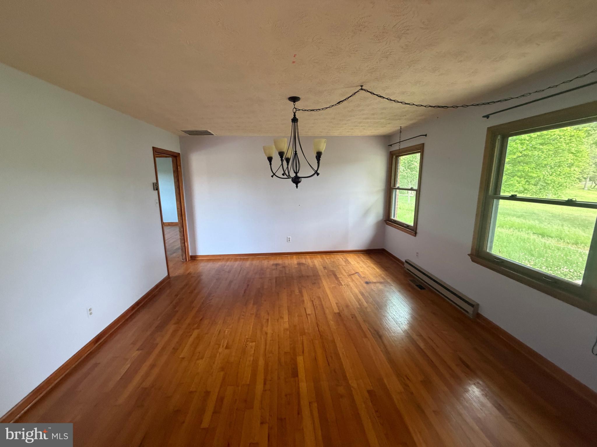 116 Rehoboth Lane Summit Point, WV 25446 - Photo 4 of 14 a view of empty room with wooden floor and fan