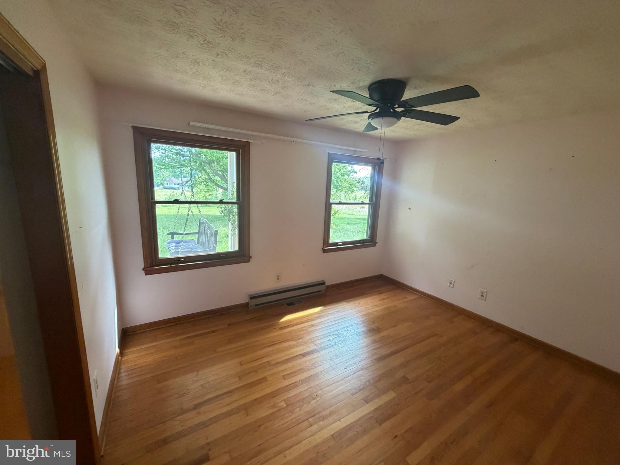 116 Rehoboth Lane Summit Point, WV 25446 - Photo 8 of 14 an empty room with windows and a ceiling fan