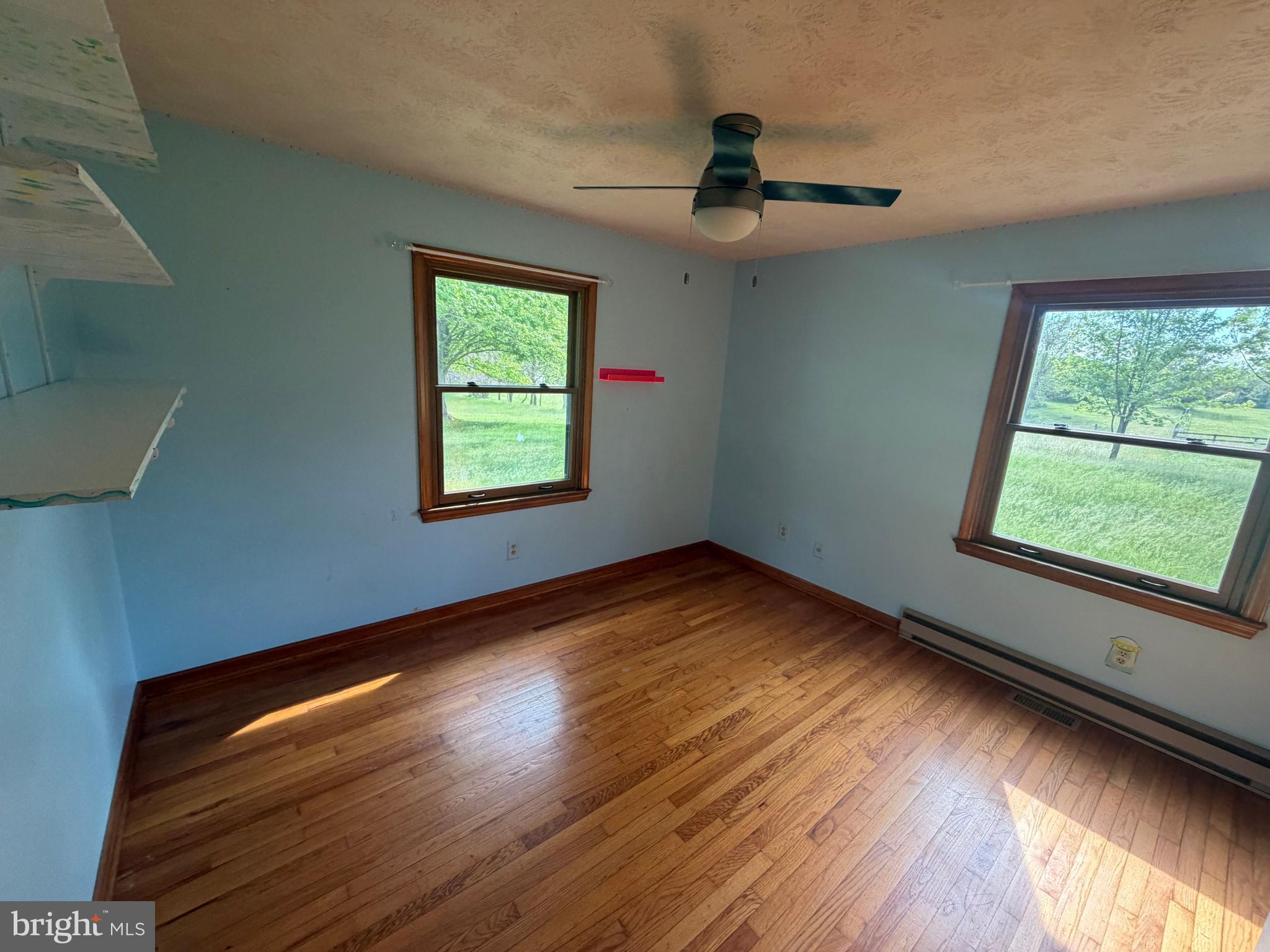 116 Rehoboth Lane Summit Point, WV 25446 - Photo 9 of 14 a view of empty room with wooden floor and fan