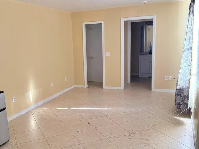 a view of an empty room and closet area
