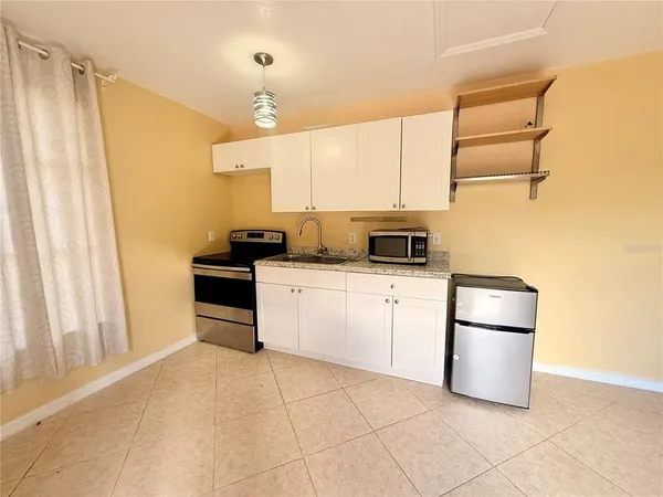 a kitchen with a sink cabinets and stainless steel appliances