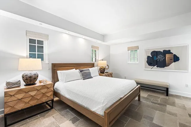 a bedroom with a bed and window