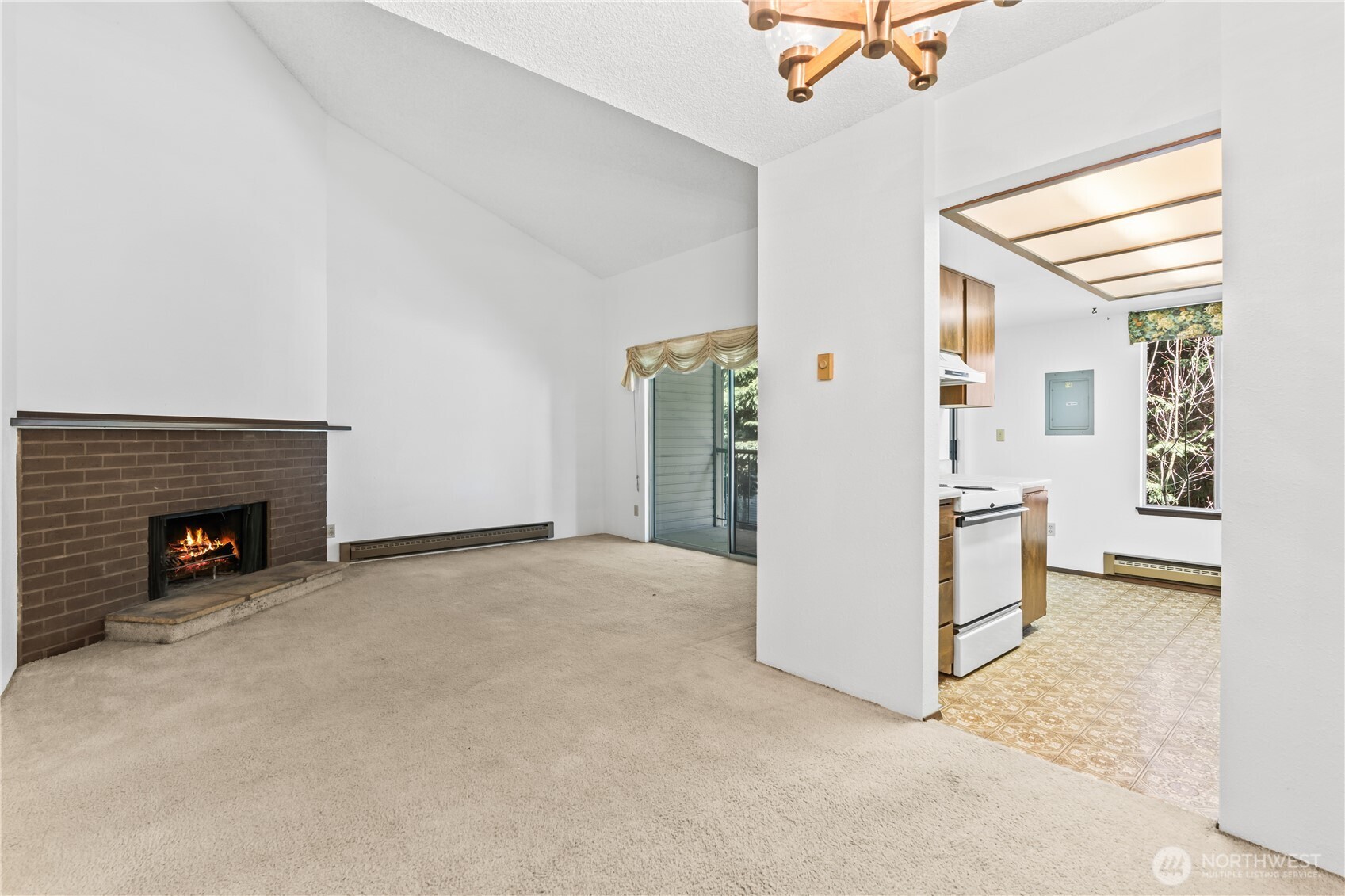 17529 151st Avenue Southeast, Unit 711 Renton, WA 98058 - Photo 11 of 25 an empty room with windows and a fireplace