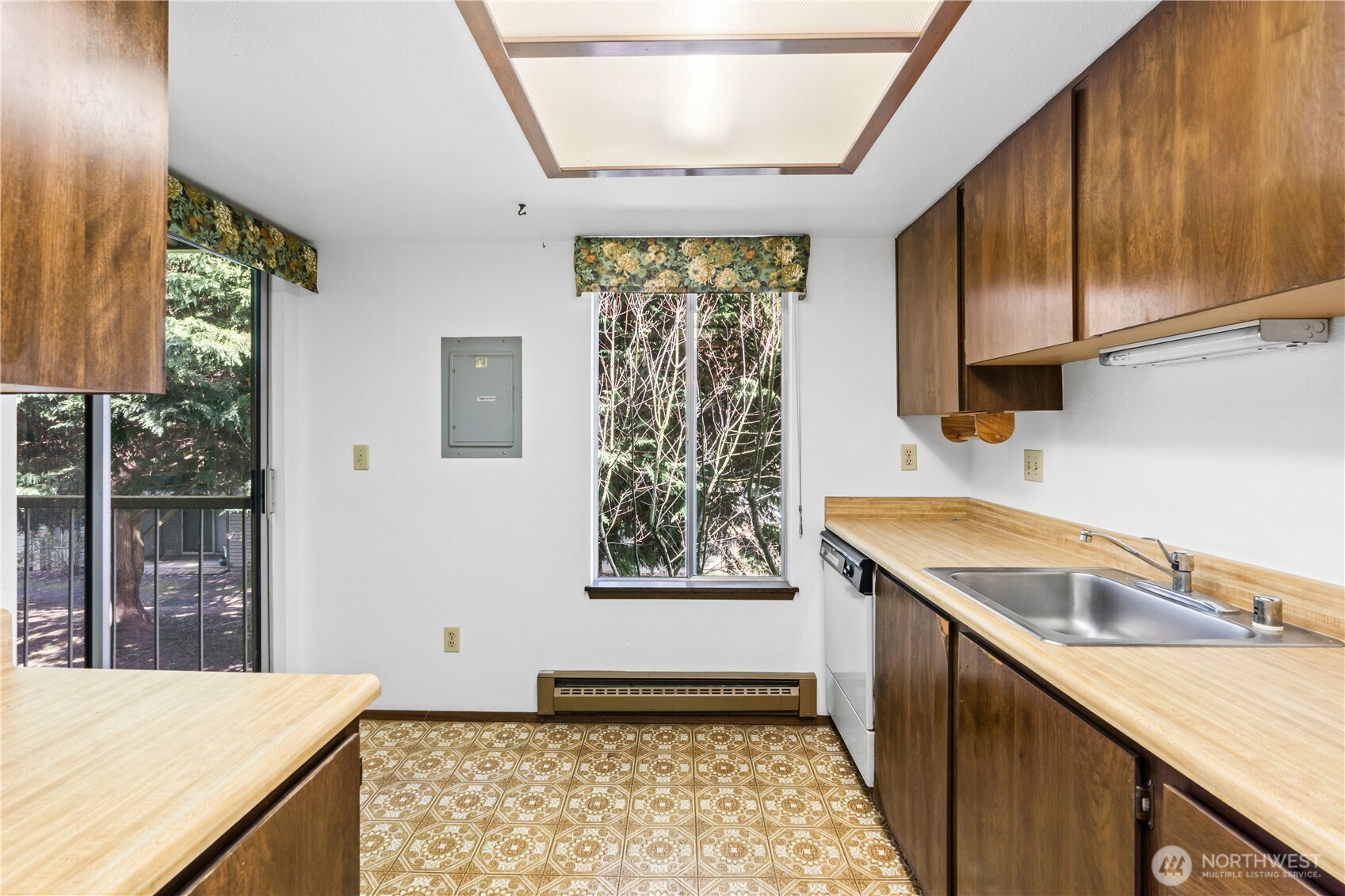 17529 151st Avenue Southeast, Unit 711 Renton, WA 98058 - Photo 12 of 25 a kitchen with a sink window and cabinets