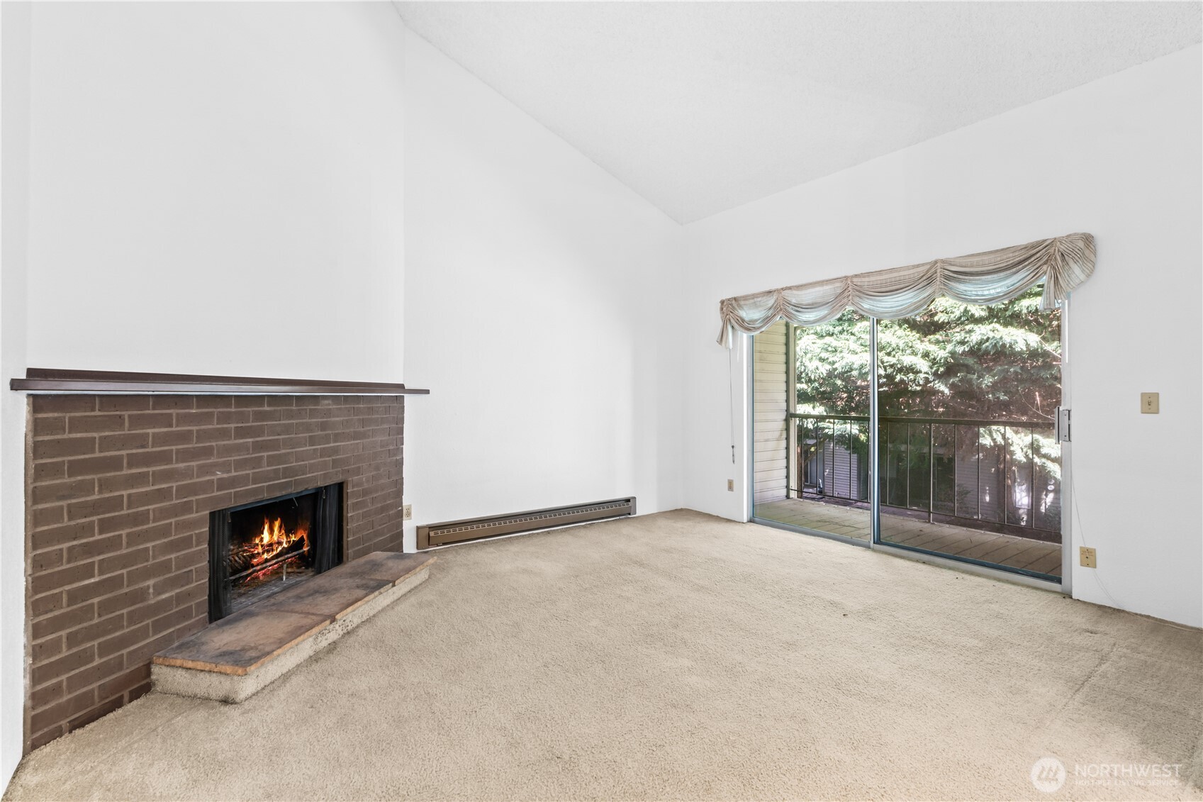 17529 151st Avenue Southeast, Unit 711 Renton, WA 98058 - Photo 7 of 25 a view of an empty room with a fireplace