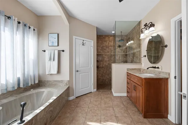 a bathroom with a sink mirror and shower