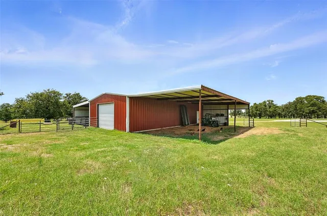a backyard of a house with yard and trampoline