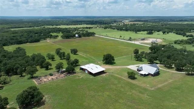 an aerial view of a house with garden space and street view