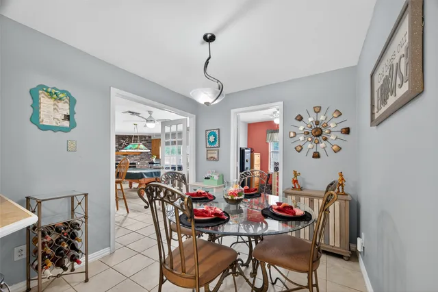 a living room with furniture a flat screen tv and a chandelier