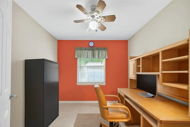 a view of a backyard with plants and a large tree