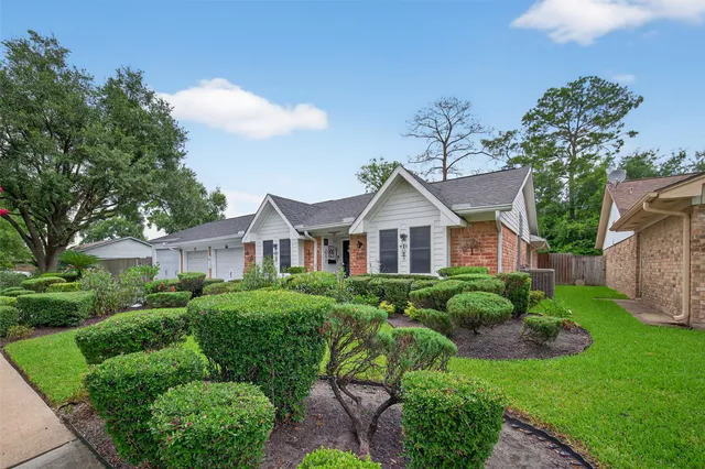a living room with furniture a flat screen tv and a window