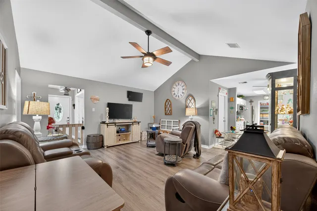 a view of a dining room with furniture and chandelier