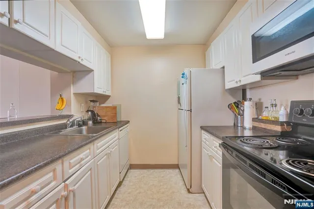 a kitchen with a sink stove and refrigerator