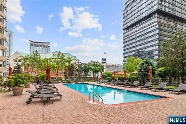 a swimming pool with outdoor seating and yard